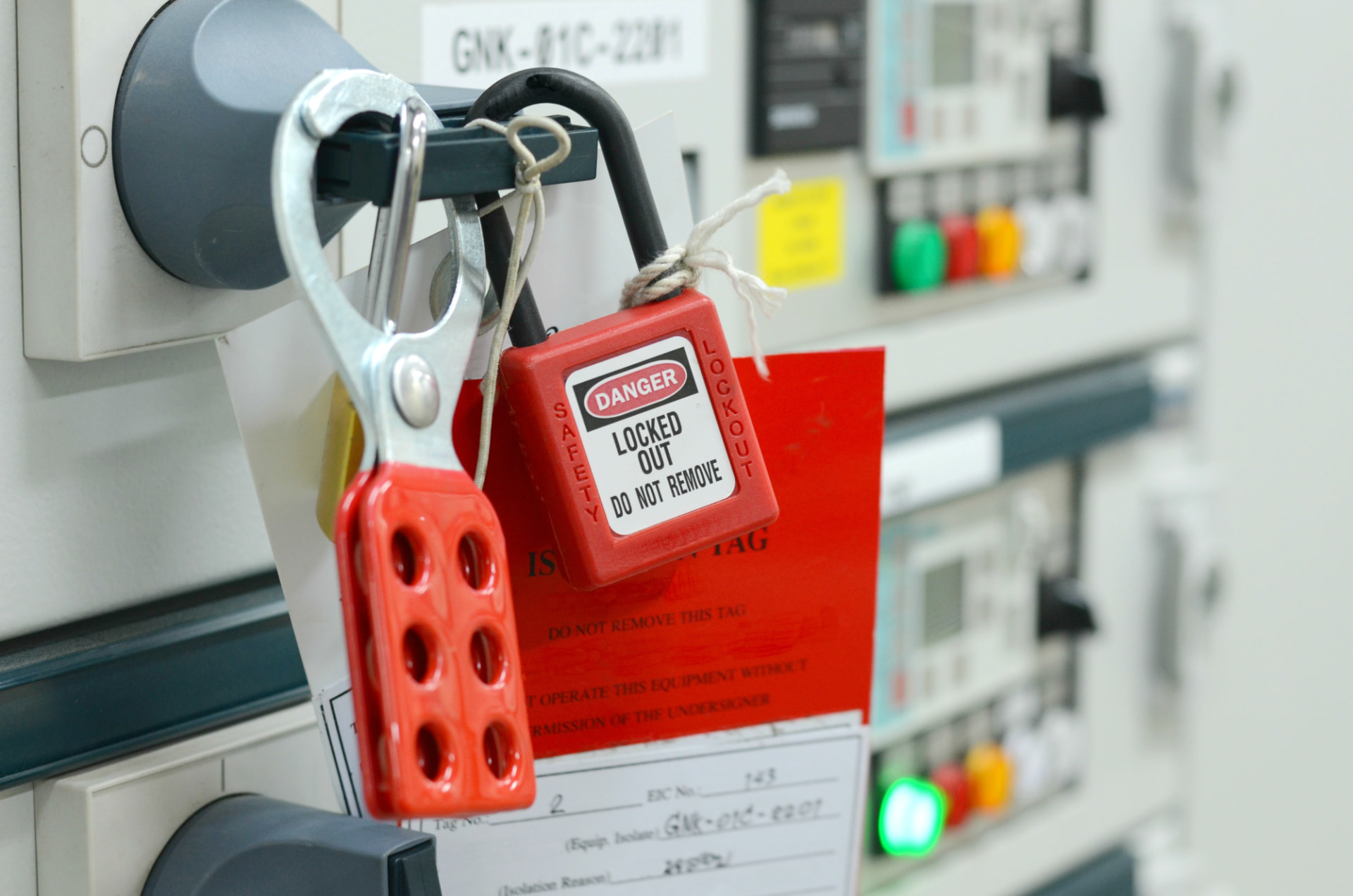 Red lockout-tagout safety lock on industrial electrical equipment
